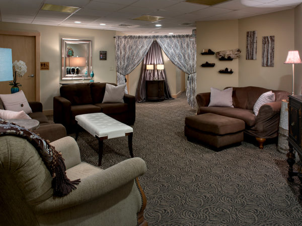 Lounge area in the spa with three brown couches and an oversized chair in this Lincoln, NH hotel