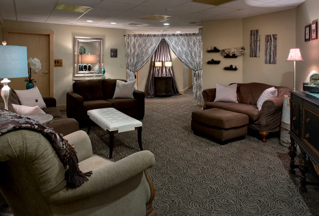 Lounge area in the spa with three brown couches and an oversized chair in this Lincoln, NH hotel